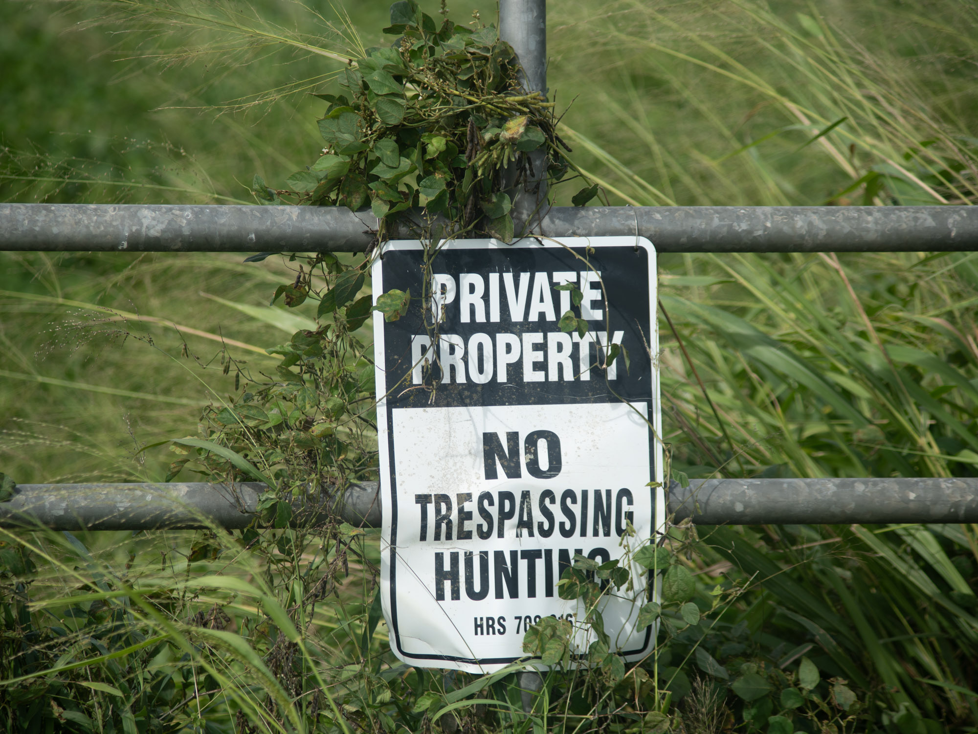 On a gate reads a no trespassing sign.