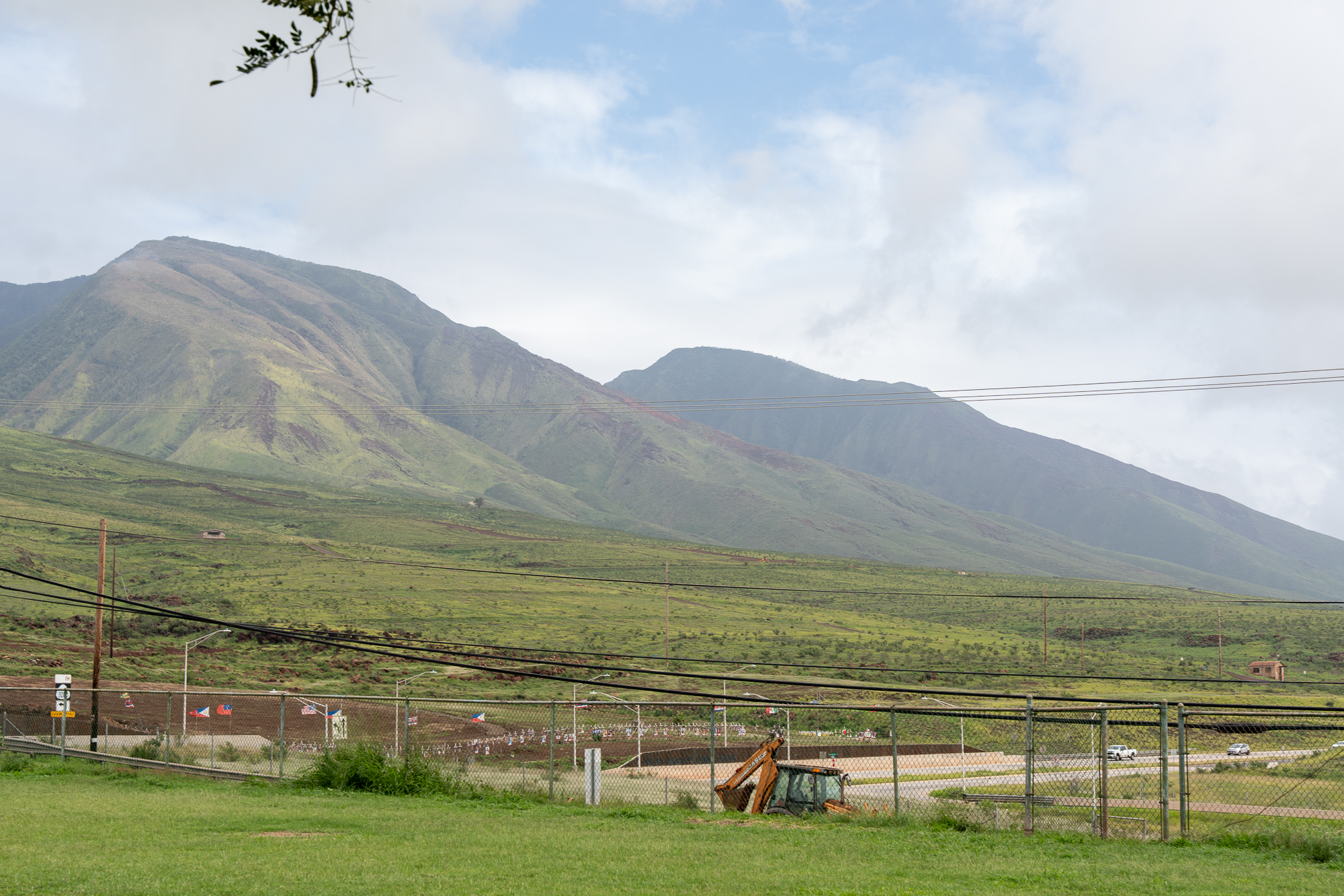 Part of the West Maui Mountains with the Lahaina Fires Memorial and the Lahaina Bypass in the foreground.